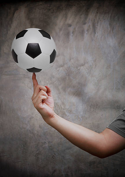 istock hand and soccer football 177410752