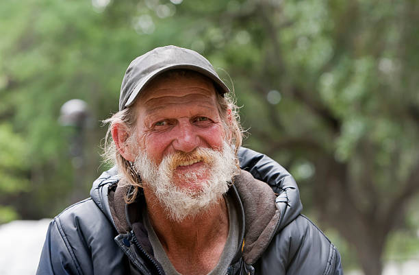 Happy Homeless Man Happy homeless man smiling outside during the day homeless person stock pictures, royalty-free photos & images
