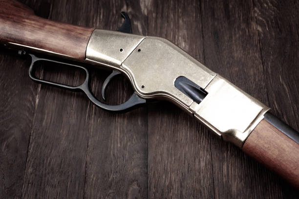 istock Old west gun. Lever action repeating rifle with ammunition 1774110499