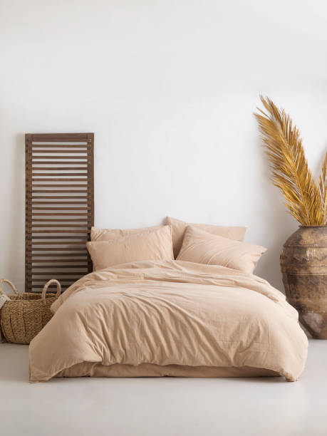istock Wooden framed comfortable bed with many pillows, blanket 1774111976