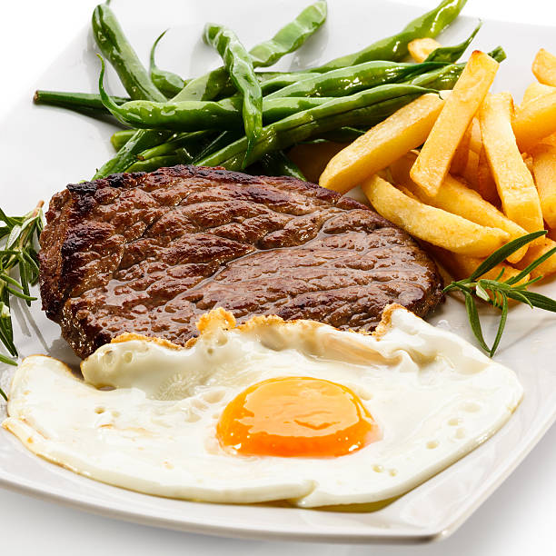 istock Beefsteak, fried egg, French fries and vegetables 177412712