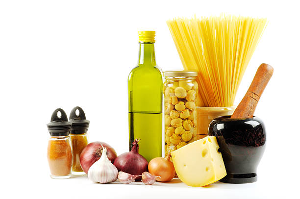 Shredding cheese and fusilli pasta on forks with vegetable ingredients