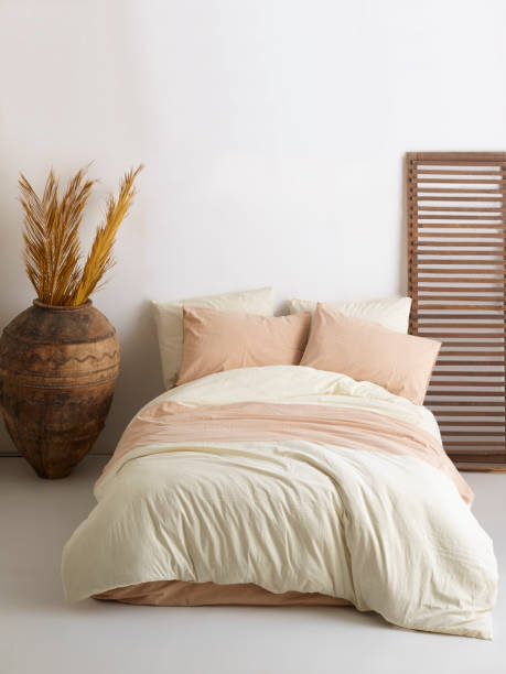 istock Wooden framed comfortable bed with many pillows, blanket 1774141008