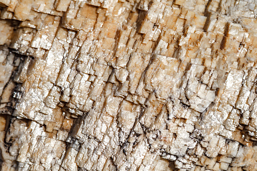 Crystals of mineral Icelandic spar with light highlights close-up, selective focus