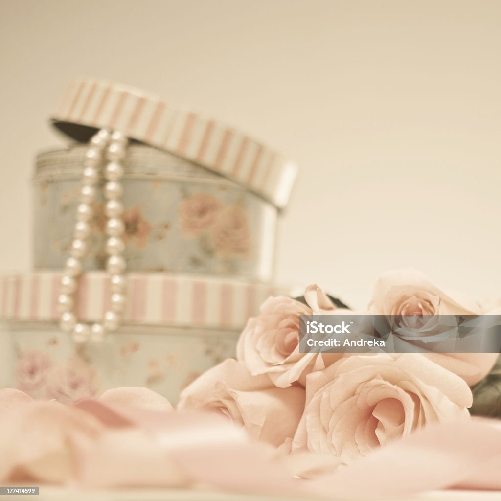 Vintage roses and pearl necklace Vintage pink roses, vanity cases and pearl necklace Make-Up Bag Stock Photo