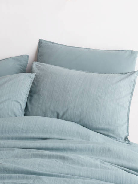 istock Wooden framed comfortable bed with many pillows, blanket 1774146326