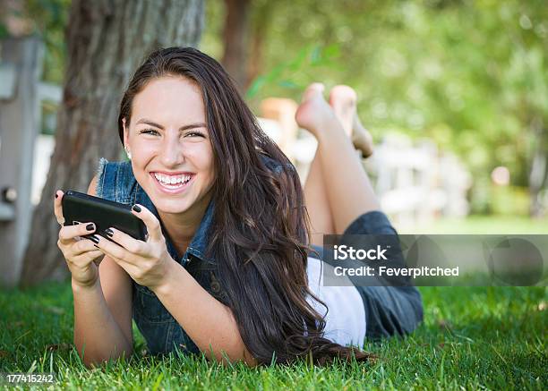 Mixed Race Young Female Texting On Cell Phone Outside Stock Photo - Download Image Now