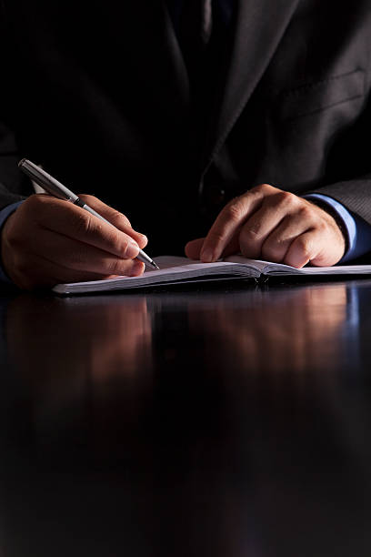 Businessman Writes in Notebook stock photo