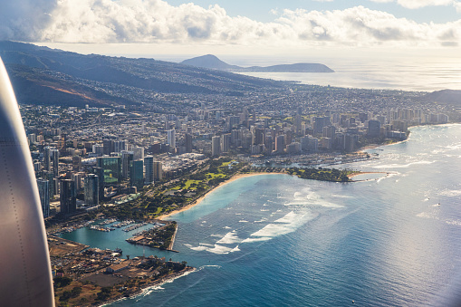 Aerial view of Honolulu city, from airplane window. Hawaii.