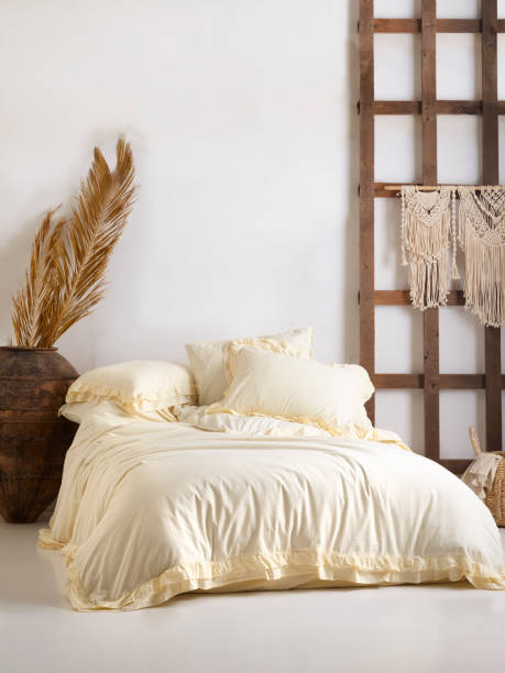 istock Wooden framed comfortable bed with many pillows, blanket 1774163674
