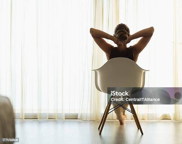 Female Sitting In Front Of Window Rear View Stock Photo - Download Image Now - Adult, Apartment, Brown Hair