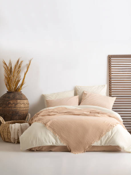 istock Wooden framed comfortable bed with many pillows, blanket 1774168954