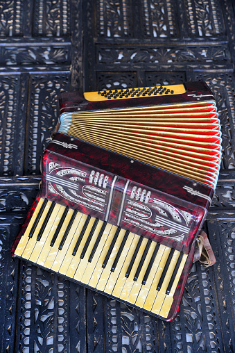Old accordion on rustic wooden surface