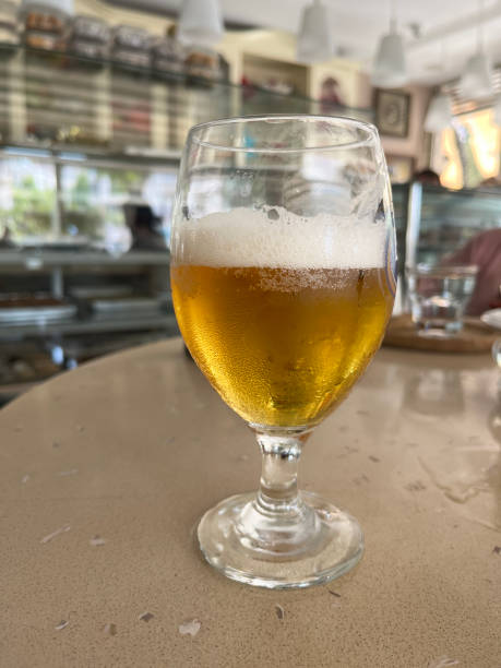 istock Half glass of beer on table 1774174494