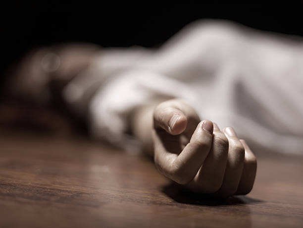 Dead woman's body with focus on hand stock photo