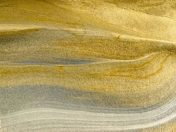Photo of Smooth surface of layered sandstone sediment rock