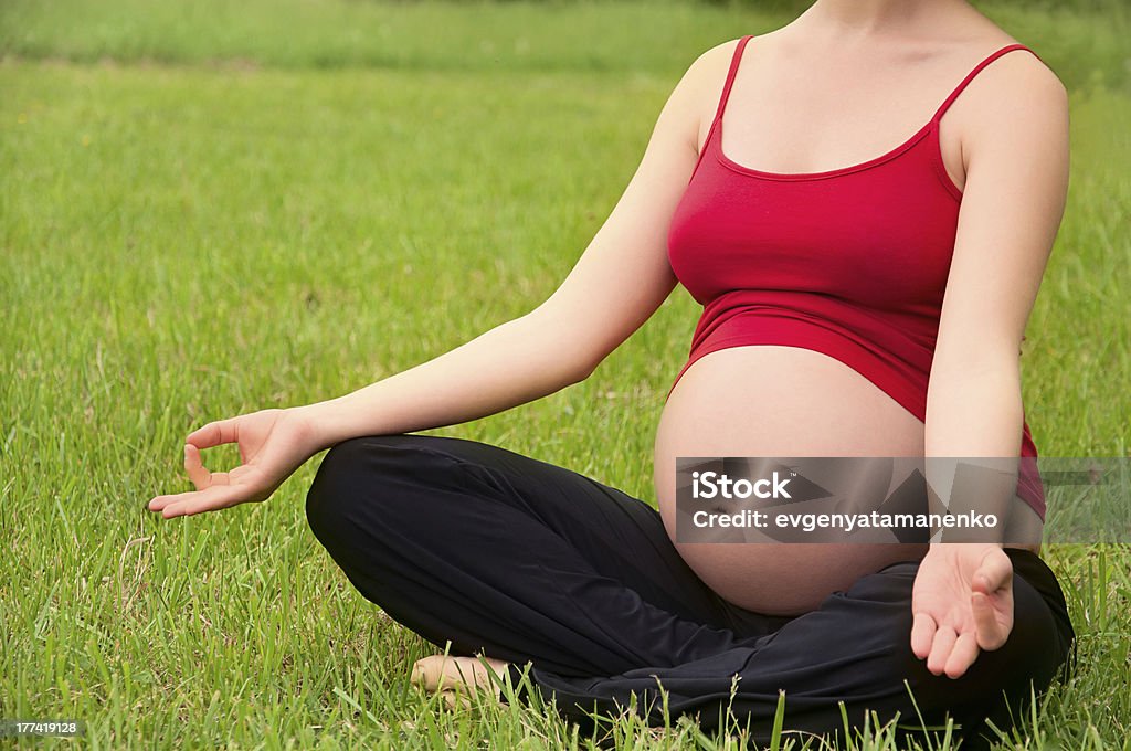 pregnant woman meditating in nature, practice yoga "pregnant healthy woman meditating in nature, practice yoga" Abdomen Stock Photo