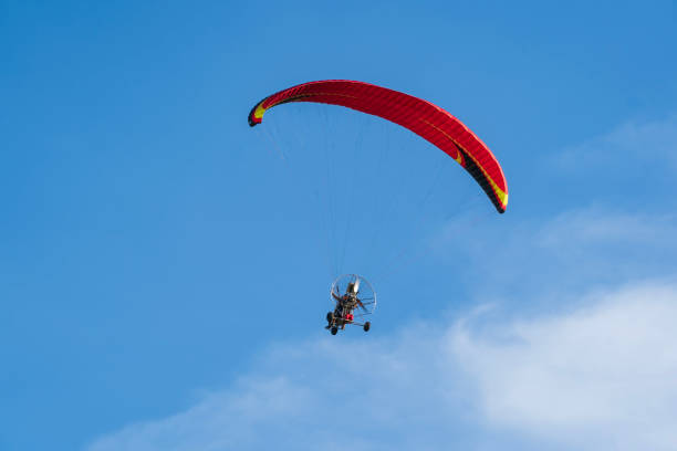 istock Flying with paramotor in the blue sky - Man riding paramotor in the blue sky background 1774192912