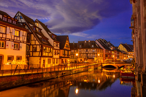 Traditional Alsatian half-timbered houses in old town of Colmar, decorated and illuminated at christmas night, Alsace, France