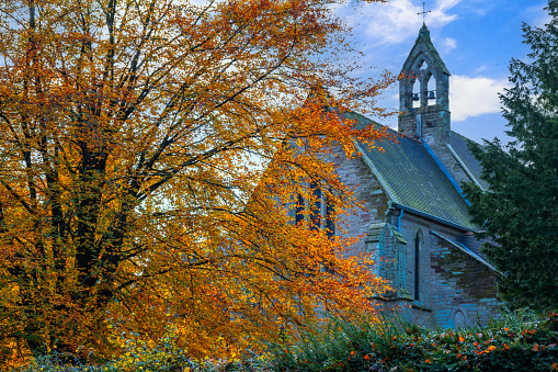 Fall foliage in front of a historic church in coastal Maine.