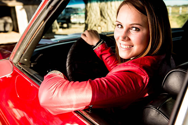 istock A young girl behind the wheel of a red car 177420607