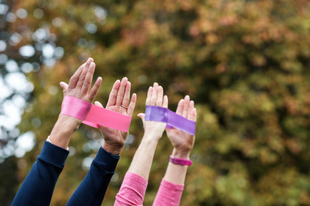 istock Mature women hands using resistance bands in park. 1774212389