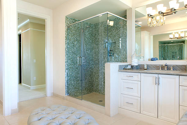 istock Large bathroom with white cabinets and green tiles 177421456