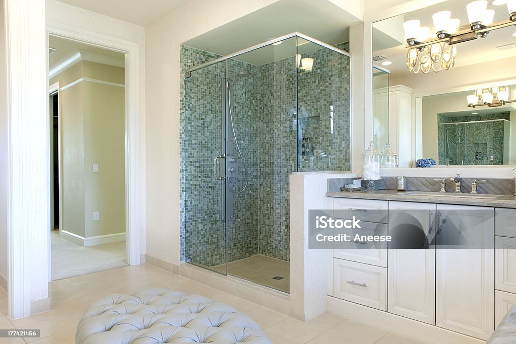 Large bathroom with white cabinets and green tiles Large upscale master bathroom with glass shower, hot tub and lots of marble tile Shower Stock Photo