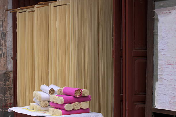 A man checks dried noodles in the greenhouse
