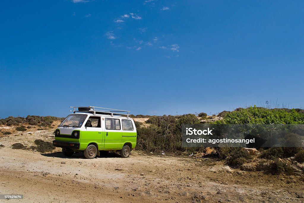 Small camper vehicle at the beach "A small camper vehicle parked at the beach in Gozo, Malta." Absence Stock Photo