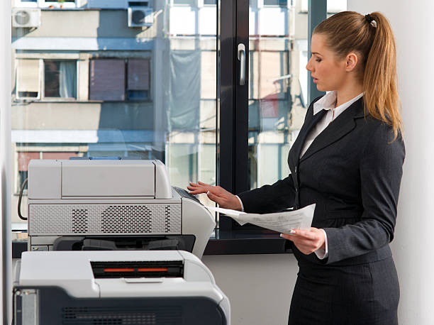 istock business woman working on printer 177421697