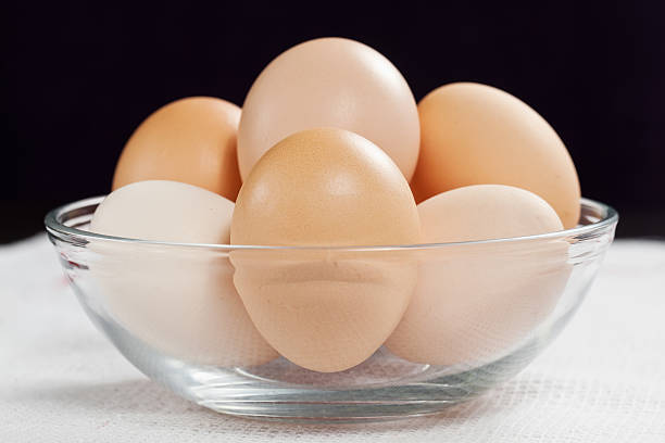 istock Fresh raw organic eggs in glass bowl on white cloth 177421813