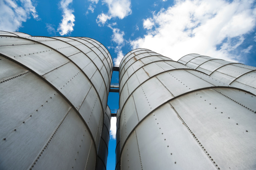 A row of grain silos set in an agricultural processing plant