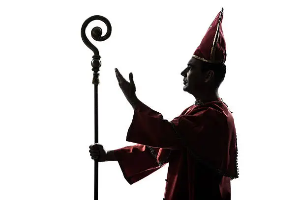 one man cardinal bishop silhouette saluting blessing in studio   on white background