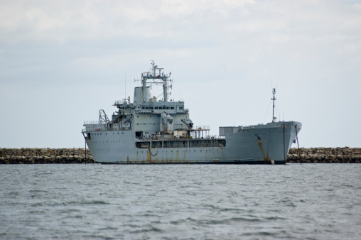 American aircraft carrier anchored in a harbour after offshore training exercises.