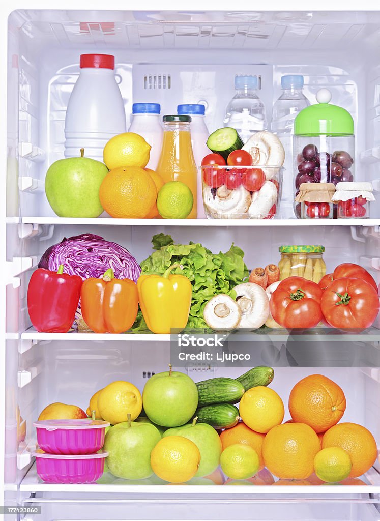 Shot of an open fridge with food products Shot of an open fridge with healthy food products Refrigerator Stock Photo