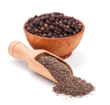 milled black pepper isolated on white background