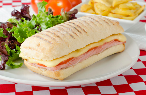 Cheese, ham and tomato toastie in a ciabatta bread served with salad and chips.