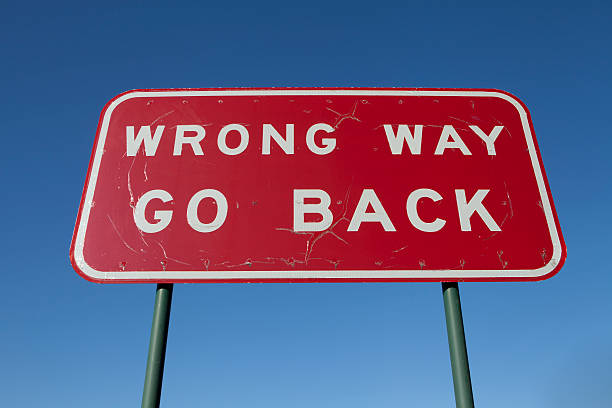 Wrong way go back sign Australian road sign telling motorists it is the wrong way back arrow stock pictures, royalty-free photos & images