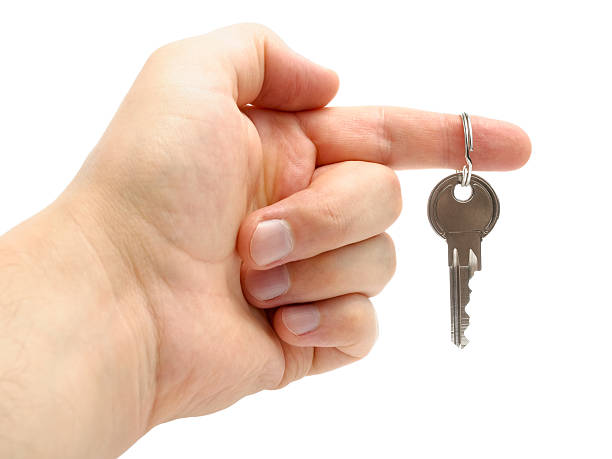 istock Hand holding a key isolated on white background 177425337