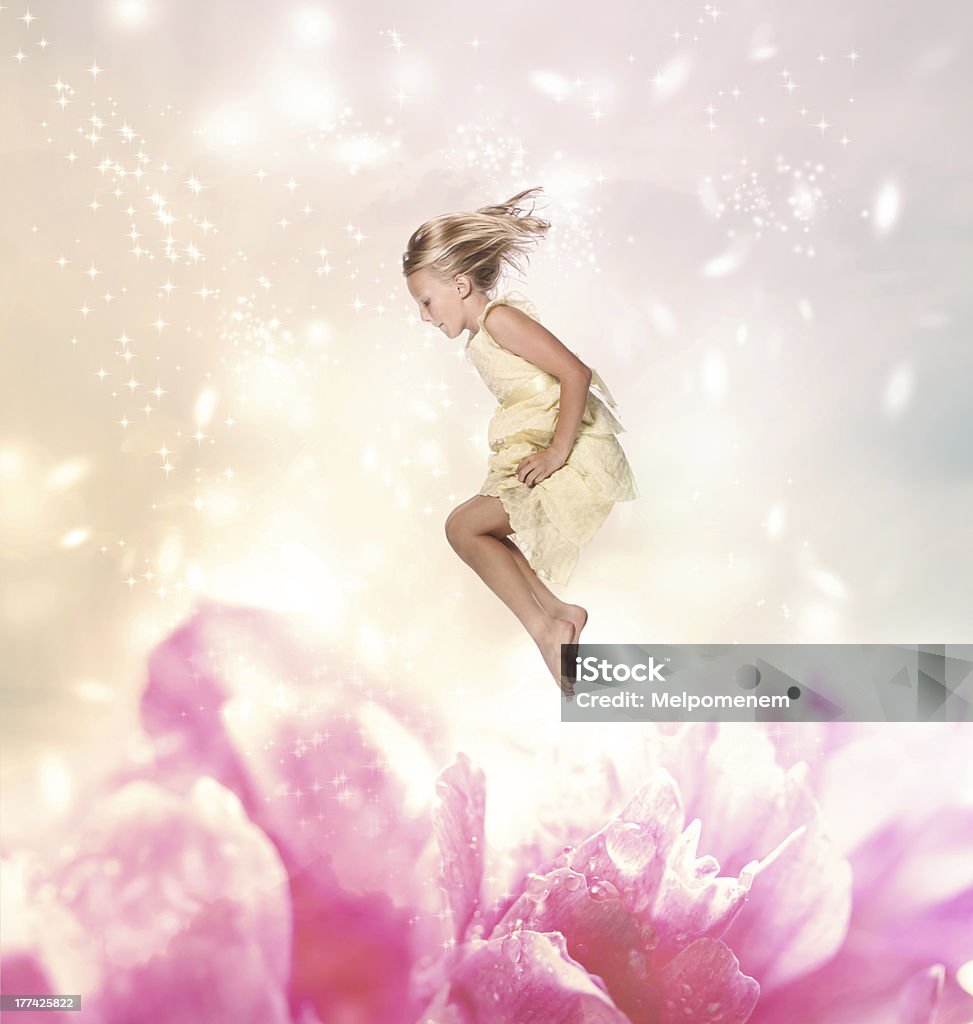 Blond Girl Jumping (Fantasy) Blond Girl Jumping into a Giant Flower Abstract Stock Photo