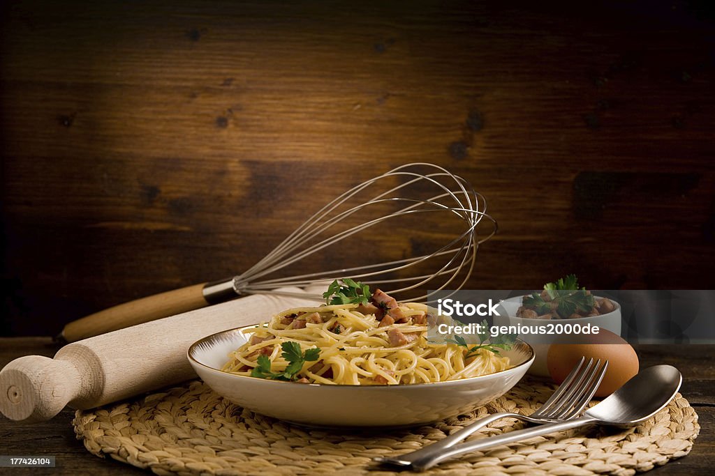 Pasta with carbonara Delicious spaghetti with bacon and egg called alla carbonara on wooden table Bacon Stock Photo