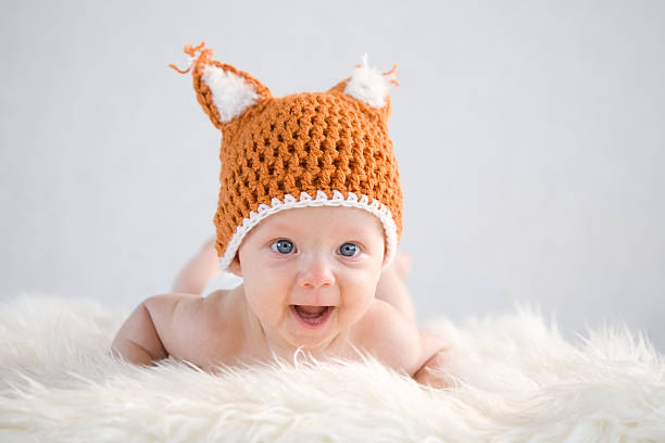 istock baby girl in a fox cap 177426236