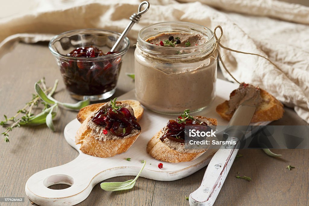 Chicken liver pate with onion jam Chicken liver pate with onion jam on bread and in jar Crostini Stock Photo