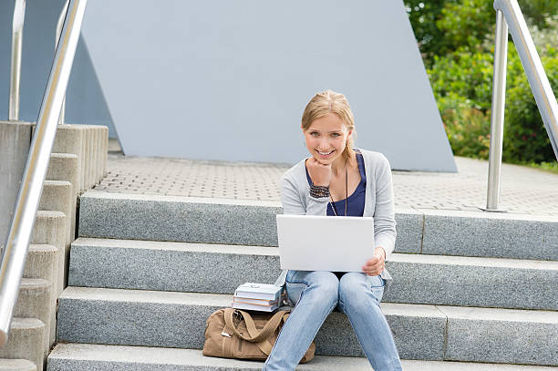 istock Young student woman sitting on university steps 177426899