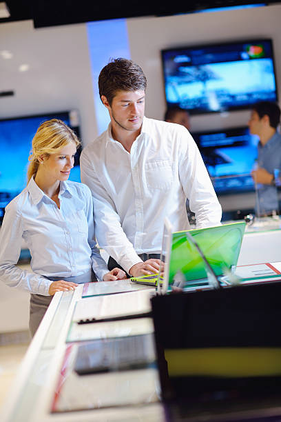 istock couple in consumer electronics store buying laptop 177426910