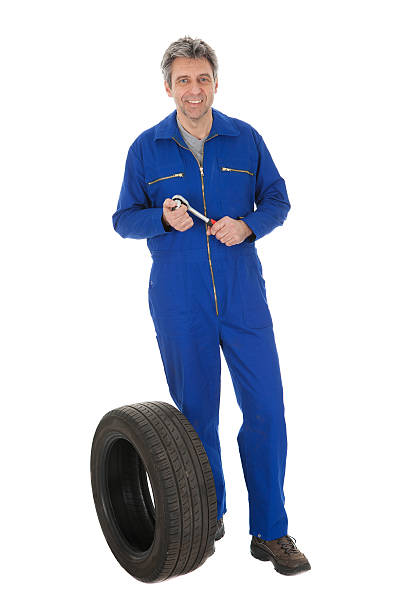 istock Automechanic standing next to car tire 177427140