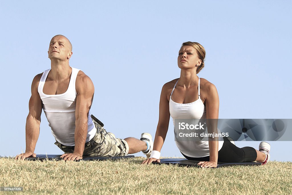 Couple exercising Couple exercising yoga in nature Active Lifestyle Stock Photo