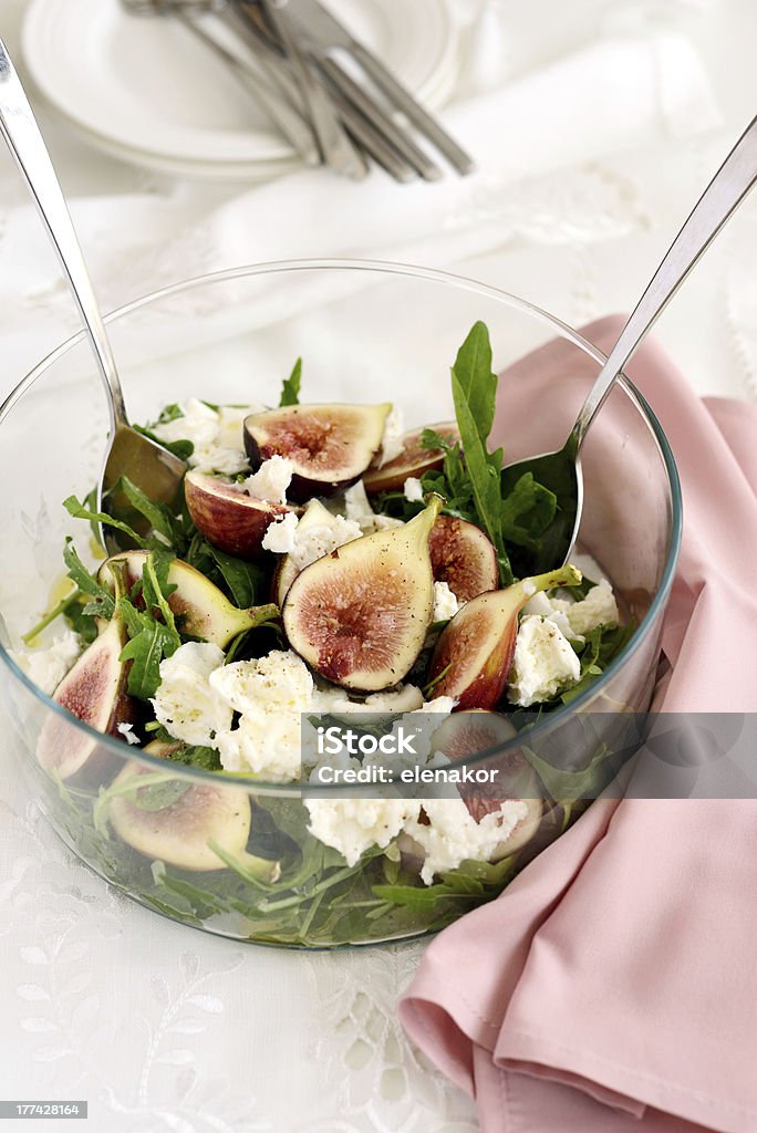 Arugula and Figs salad with Buffalo Mozzarella Arugula and Figs salad with Buffalo Mozzarella in a glass bowl Fig Stock Photo