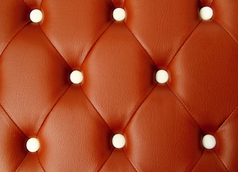 Closeup texture of vintage brown leather sofa for background.